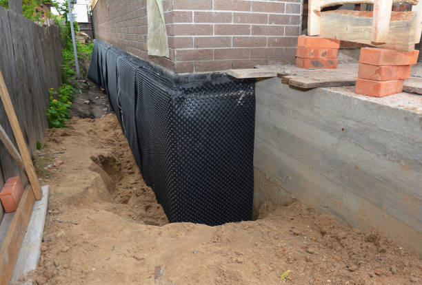 Happy homeowners after waterproofing job in Scipio